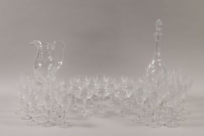 a lot of wine glasses and a decanter on the table