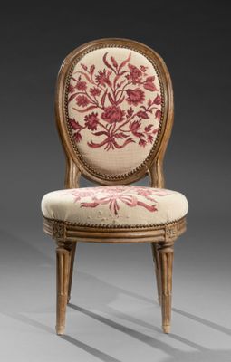 a close up of a chair with a floral design on it