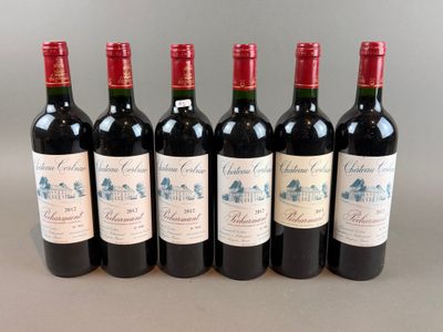 six bottles of red wine are lined up in a row