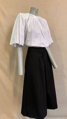 black and white skirt with a white blouse on a mannequin dummy