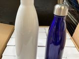 two water bottles sitting on a table next to each other