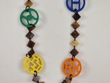 multicolored necklace with a monogram on a chain on a white background
