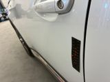 a close up of a car door handle with a sticker on it