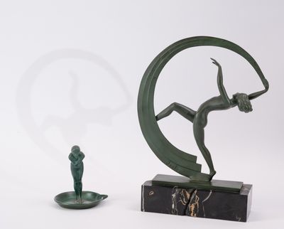 statue of a man on a crescent with a man holding a sword