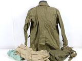 a jacket and pants that are on a white surface