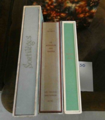three books that are sitting on a shelf next to each other