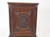 an old wooden cabinet with a carved door on top of it
