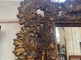 a mirror hanging on a wall in a room