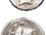 a close up of two silver coins on a white surface