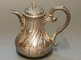 silver plated tea pot with a lid and a handle