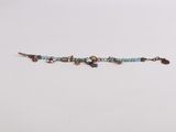 a close up of a beaded bracelet on a white surface