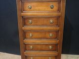 an old wooden chest of drawers with brass pulls