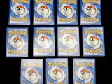 six packs of pokemon trading cards sitting on top of a table