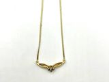 a gold necklace with a heart shaped pendant on a chain