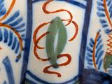 a close up of a decorative vase with blue and orange designs
