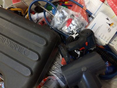 a black case sitting on top of a pile of assorted items