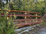 a wooden fence that is next to a gravel road