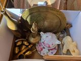 a box with a tea pot, a tea cup, and other items in it