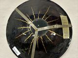 a black and gold plate with a lightning design on it