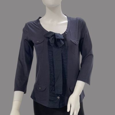 a mannequin wearing a black top and black pants