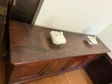 a wooden dresser with a bowl on top of it