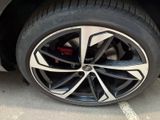 a close up of a tire on a car in a parking lot