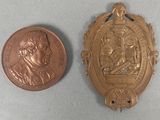 an image of a coin and a medal on a table