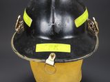 a close up of a fireman ' s helmet on a black background