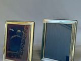 three picture frames sitting next to each other on a table