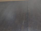 a cat that is sitting on top of a wooden table