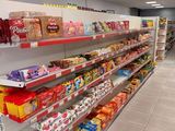 many shelves in the store that are filled with food