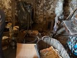 a man that is standing in a room with many items