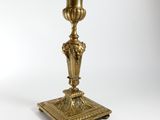 an image of a brass candle holder on a white background