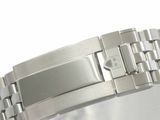 a close up of a watch on a white surface