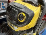 a yellow and black blower sitting on top of a pile of trash