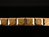 a gold bracelet with five different types of coins on it