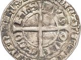 une vieille pièce d'argent ornée d'une croix