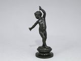 a bronze statue of a woman holding a bird on top of a pedestal