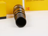 a yellow box and a black tube on a white surface