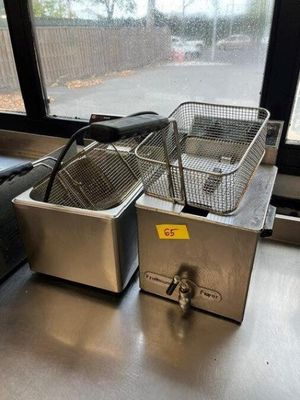 two deep fryers sitting on the counter in the kitchen