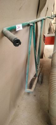 a hose attached to a wall next to a water tank