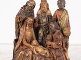 statue of a group of people sitting around a manger with a baby