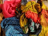 a pile of clothes in a box on the floor