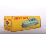 a box of dinky toys sitting on a white surface