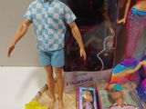 three dolls that are in a box on a table