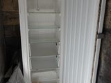 a white refrigerator with its door open in a room