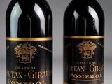 two bottles of wine sitting next to each other on a table
