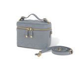 the small grey bag with a strap is sitting on a white surface