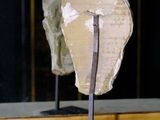 a sculpture of a head on a stand in a room