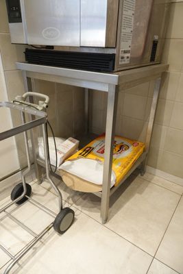 a microwave sitting on top of a cart in a kitchen